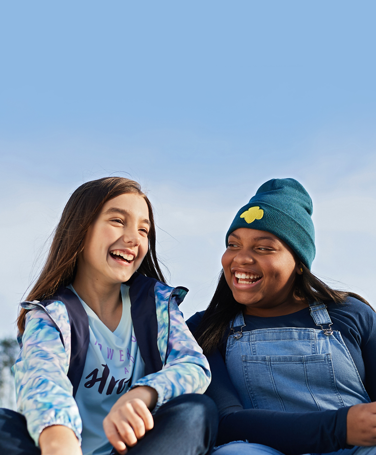 two girl scouts laughing